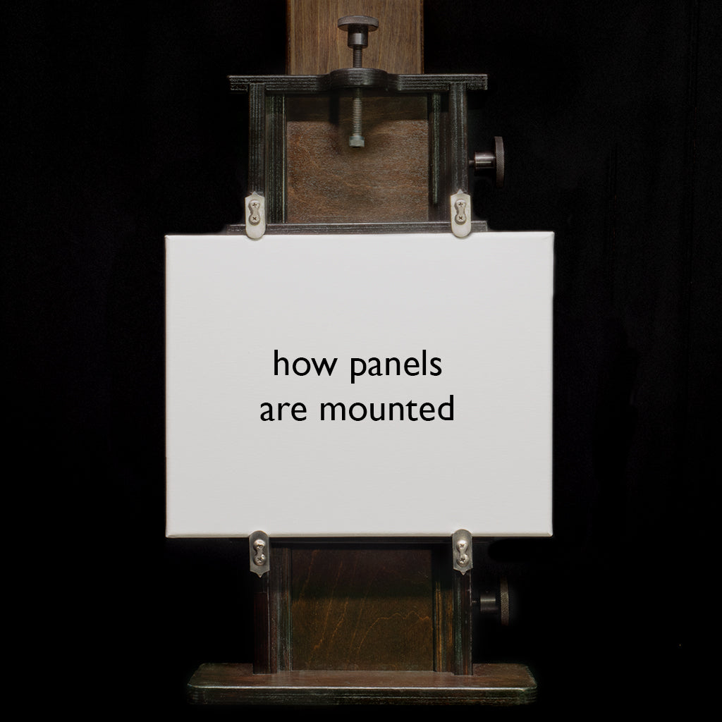 Small panel mounted in the Geneva Studio Easel clamps on a dark background