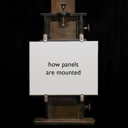 Small panel mounted in the Geneva Studio Easel clamps on a dark background