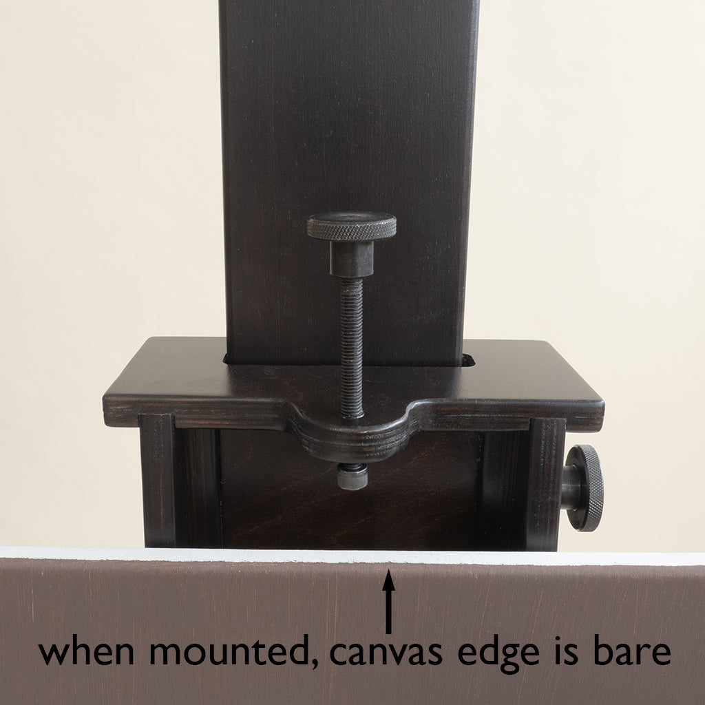 Close-up of the Geneva Studio Easel canvas holder, with the bare canvas edge visible when mounted